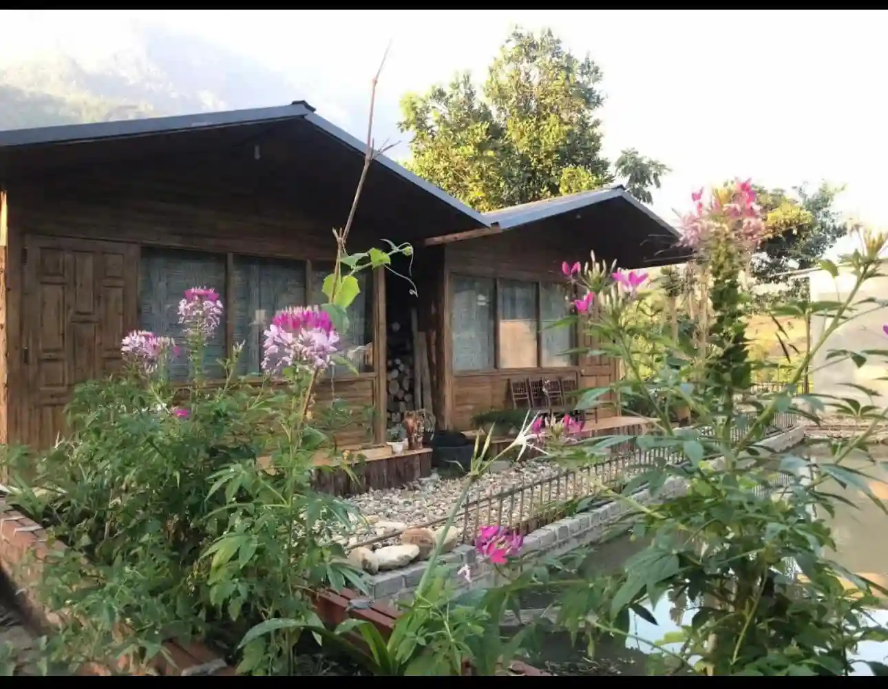Wooden homestay house with flowers and garden in a Sapa valley