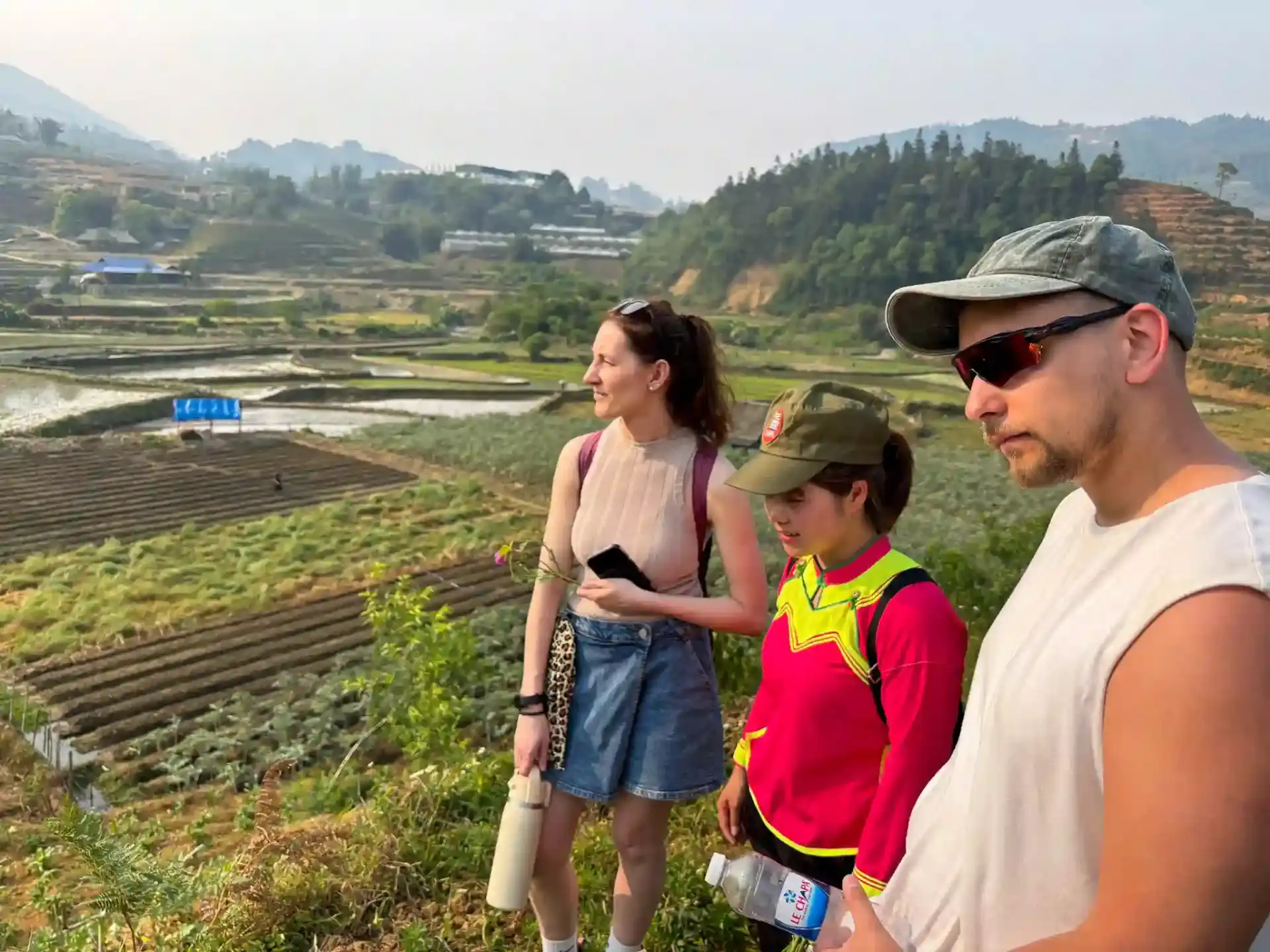 Travellers on the Sapa Countryside Walking Tour overlooking rice terraces with a Black H'mong guide